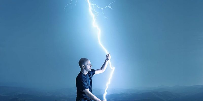 man holding a streak of lightning with two hands