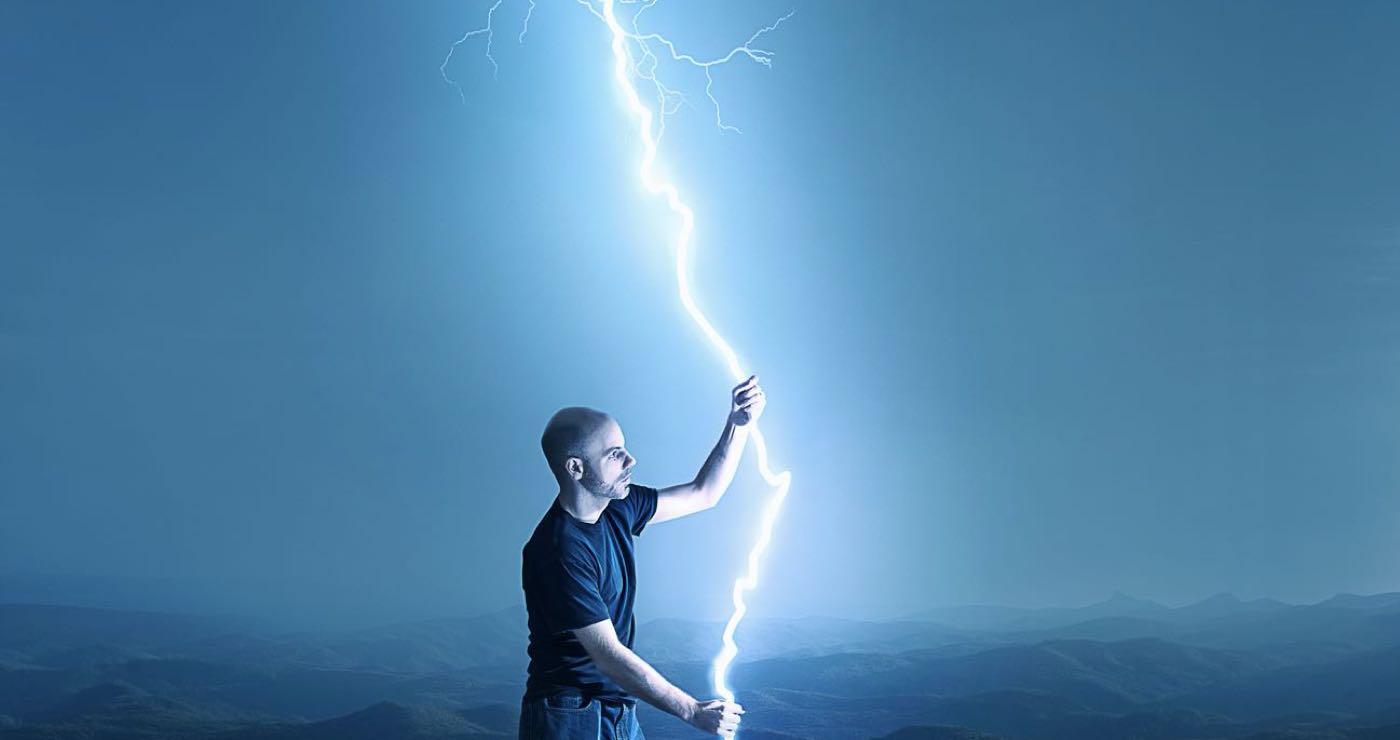 man holding a streak of lightning with two hands