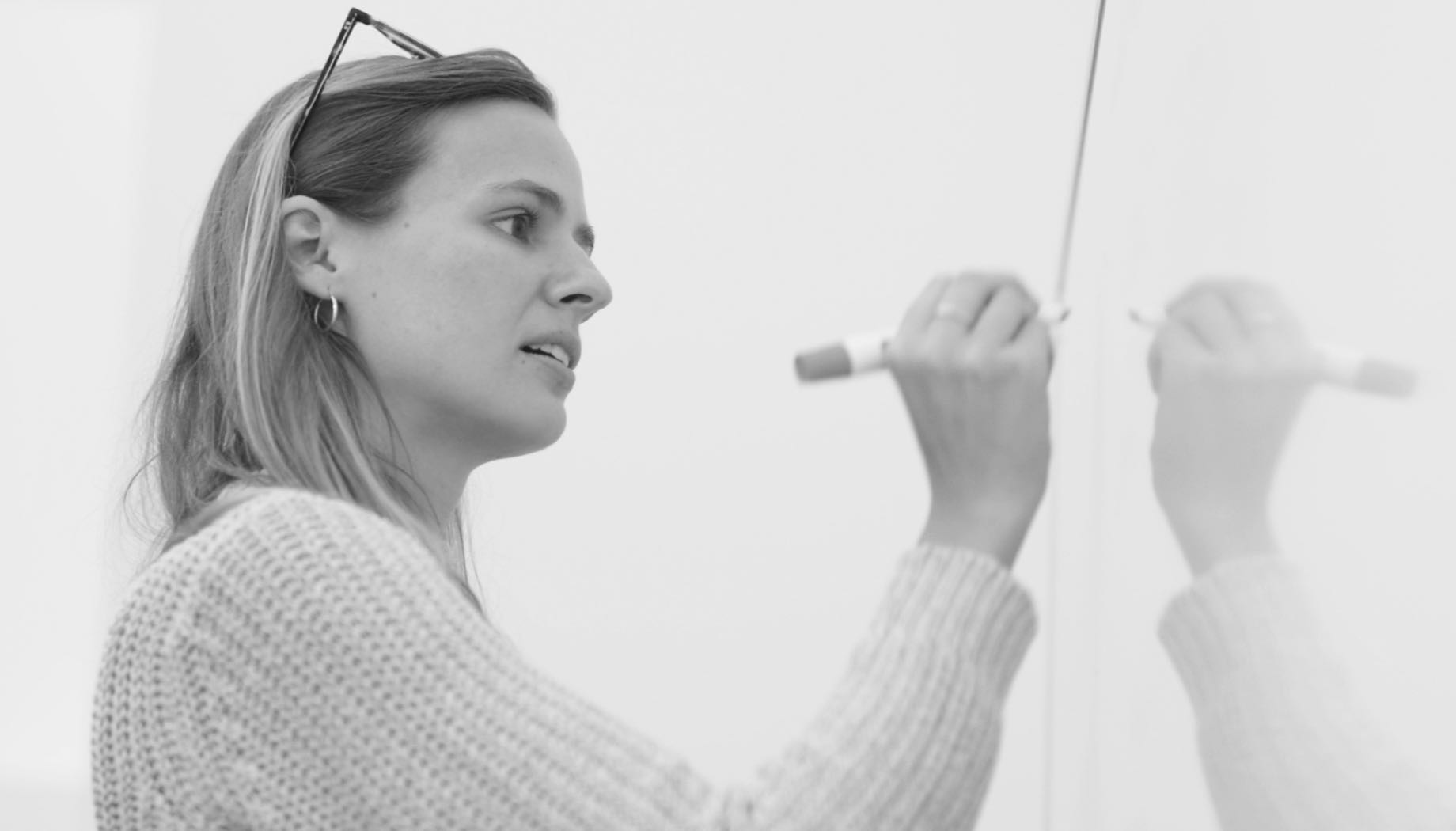 woman writing on whiteboard