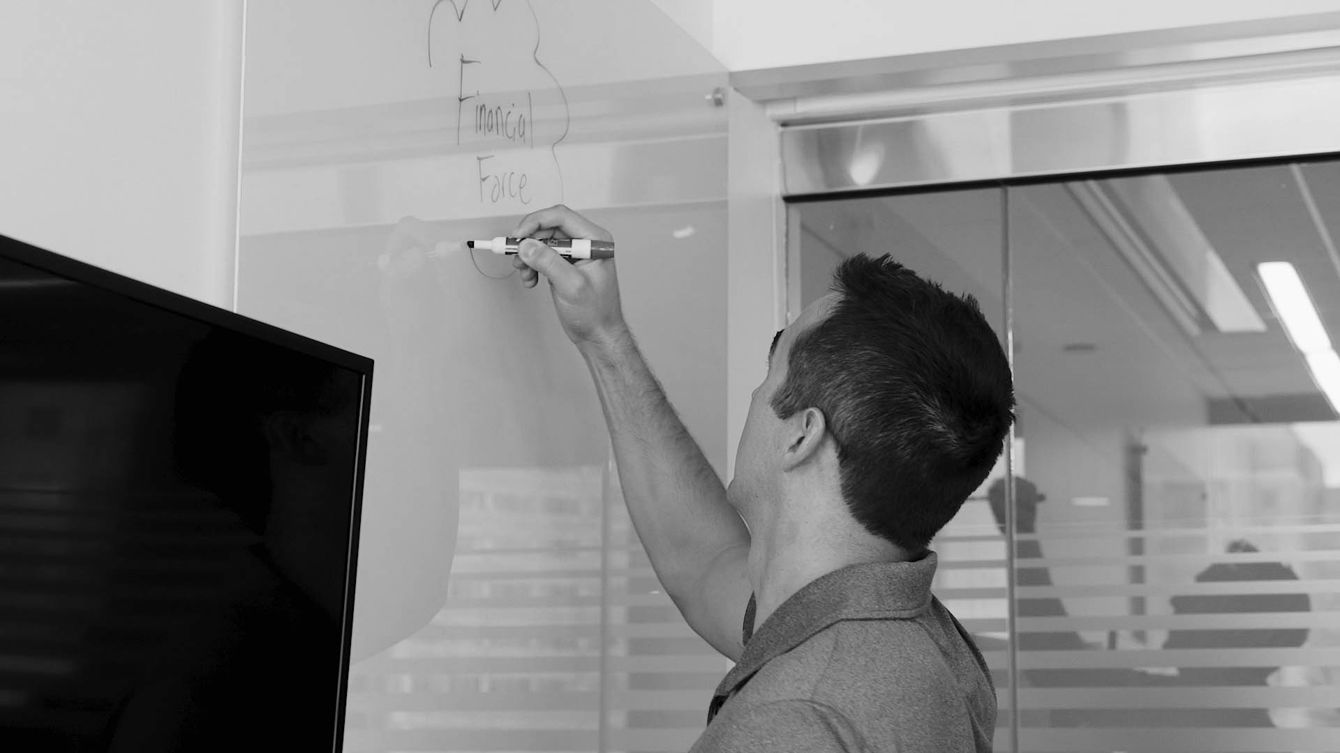 man drawing a diagram on a whiteboard