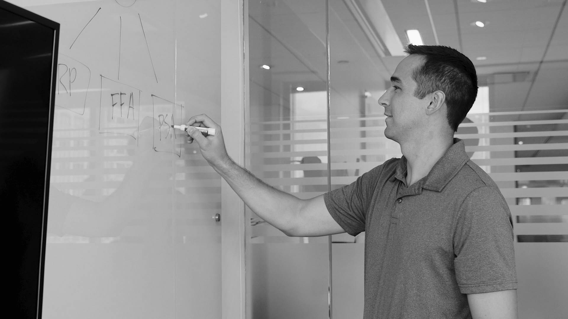 man drawing a diagram on a whiteboard